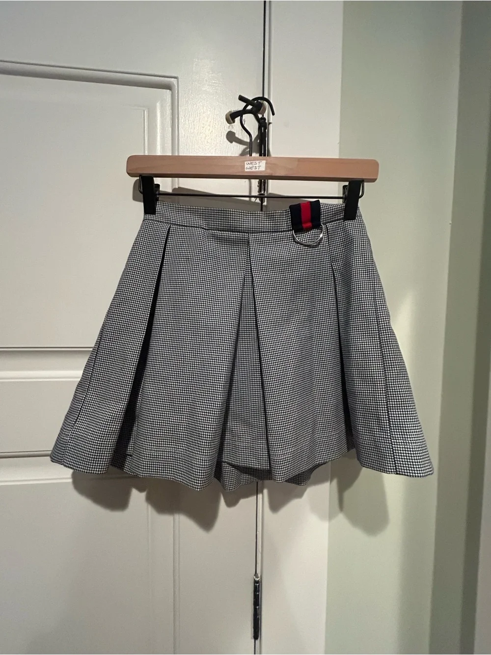 Black-and-White Checked Pleated Mini Skirt with Contrast Tab